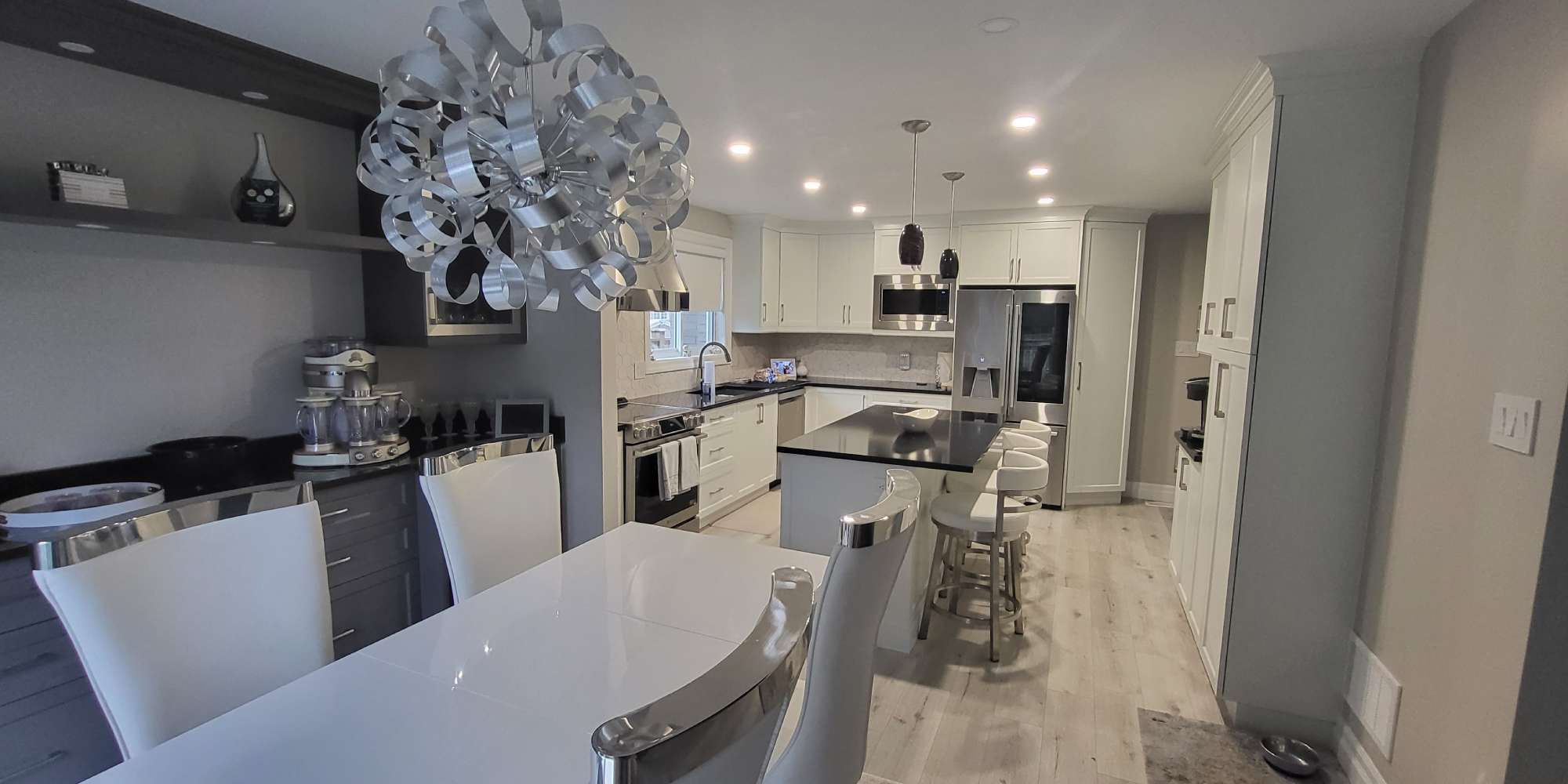 a kitchen with a table and chairs and a chandelier hanging from the ceiling