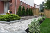 a brick house with landscaping in front of it