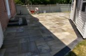 a back yard with a patio and a fence