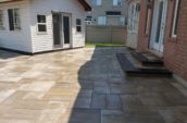 a back yard with a patio and a fence