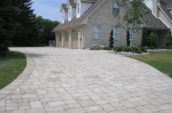 a brick driveway in front of a house